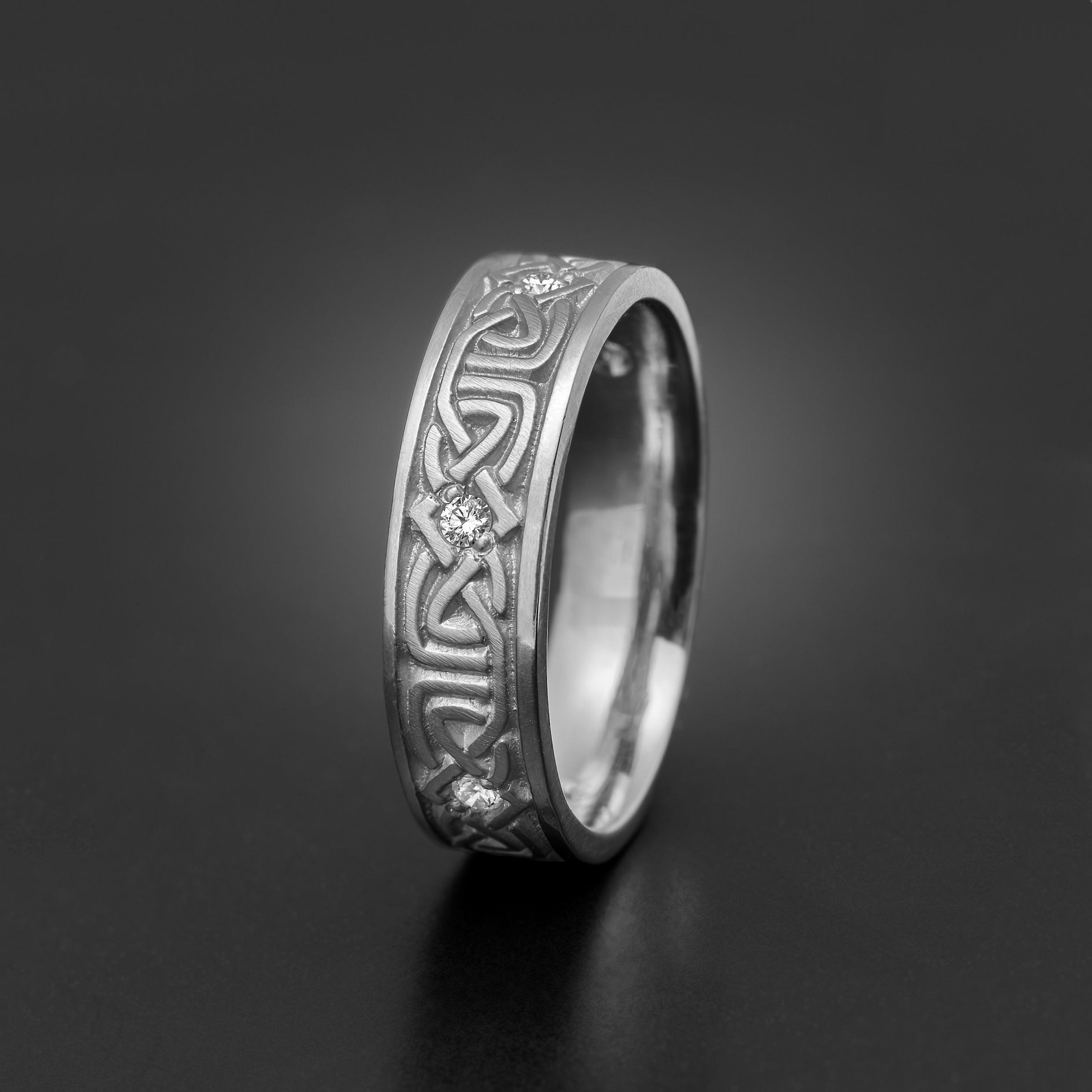 Narrow Labyrinth Celtic wedding band with diamond accents in platinum